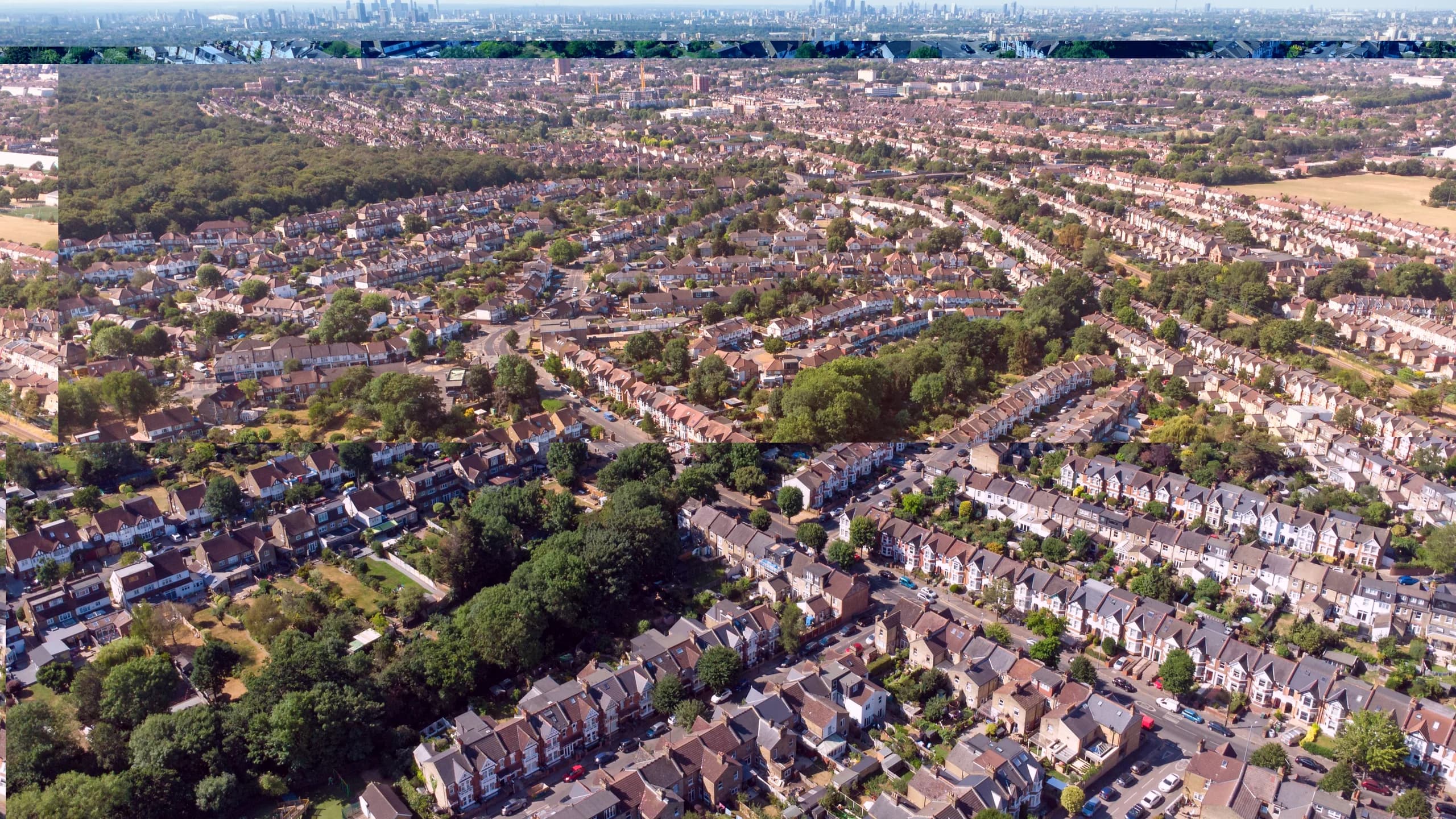 Aerial view Highams Park, a residential neighbourhood surrounded by forest and green parks on the outskirts of London