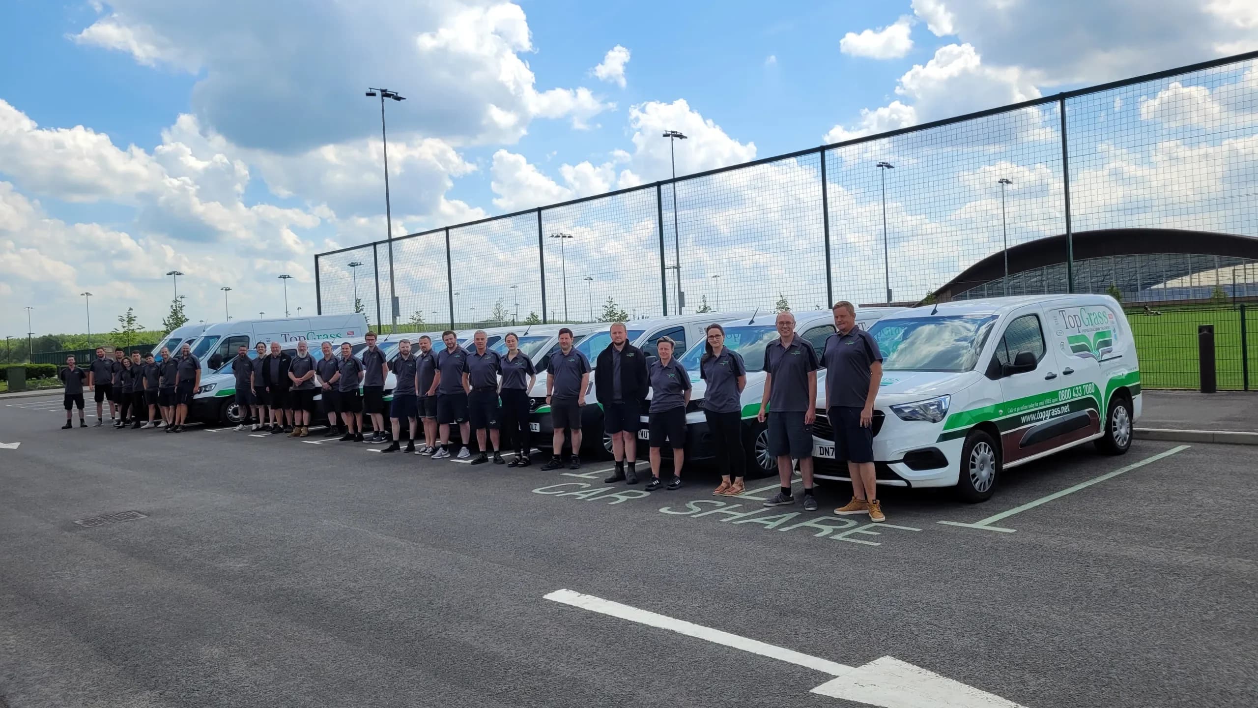 Team photo of TopGrass and TopGrass vans